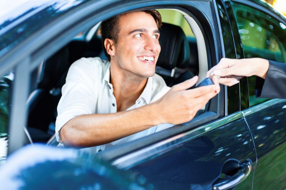 Man buying car handing keys