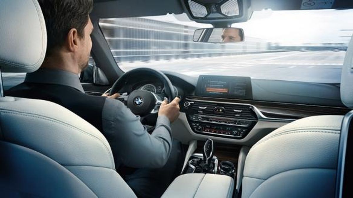 BMW Connected Drive man driving cockpit